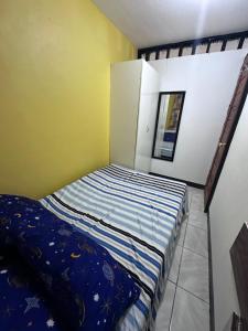 a small bedroom with a bed in a room at Stay at Amazing Grace, whole unit- VCDU subdivision , Mabini Plains in Mabini