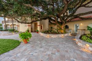 a house with a large tree in the driveway at Inn at Camachee Harbor by CoolVacay in St. Augustine
