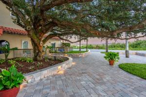 a brick walkway with a tree in front of a house at Inn at Camachee Harbor by CoolVacay in St. Augustine