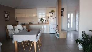 a kitchen with a table and a white refrigerator at Wind Rose Apartments Sumartin in Sumartin +20 photos