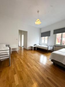 a large bedroom with a bed and a wooden floor at Lägenhet Centrum Karlshamn in Karlshamn