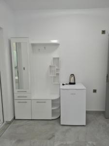 a white kitchen with a sink and a refrigerator at Silitur Keramoti in Keramoti +67 photos