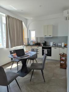 a kitchen with a table with a laptop on it at Silitur Keramoti in Keramoti
