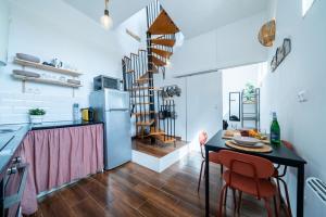 a kitchen with a table and a dining room at Casa do Vento in Aljezur +17 photos
