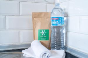 a bottle of water sitting next to a paper bag at Casa do Vento in Aljezur