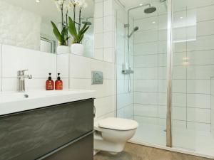 a bathroom with a shower and a toilet and a sink at Blakeskerra Barn in Kenfig +7 photos