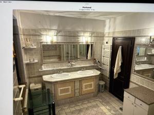 a bathroom with two sinks and a mirror at Villa Maya in Portorož +13 photos