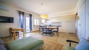 a living room with a table and a dining room at Solemar Sicilia - Casa Bella in Bagheria