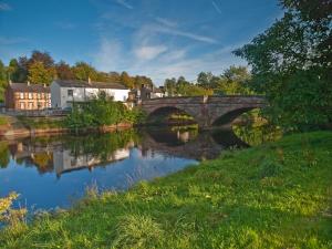 a bridge over a river in a small town at Cruck End - E3749 in Crackenthorpe