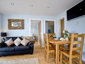 a living room with a couch and a table at Dunlin 1 - The Cove in Brixham