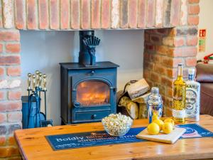a table with a wood stove in a living room at The Big Old Dairy in Weston-super-Mare