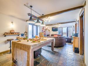 a kitchen and living room with a large dining table at The Big Old Dairy in Weston-super-Mare +49 photos