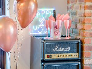 a vintage radio with pink balloons and a sign at The Big Old Dairy in Weston-super-Mare