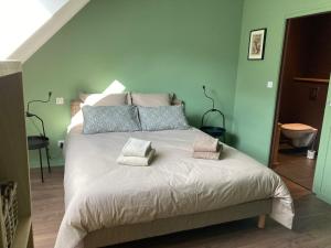 a bedroom with a bed with two pillows on it at Les Griottes Gite de charme in Verdigny