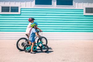 a man and a boy standing next to a bike at Sugarloaf Key RV Resort & Cottages in Summerland Key +33 photos