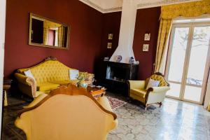 a living room with a couch and two chairs at Villa Castiglione 1863 - The real Sicilian holiday in Ragusa
