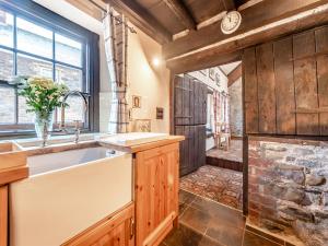 a kitchen with a sink and a large window at Yr Hen Efail in Abergorlech