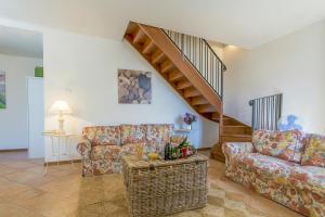 a living room with two couches and a staircase at Casa Al Prato Apt. F in Varenna