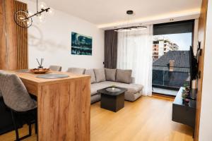 a living room with a couch and a table at Hedonist Wellness & Spa in Zlatibor