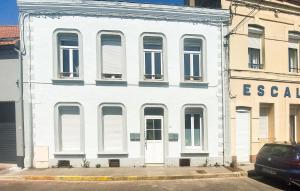 a white building with white doors and windows at Appartement Proche Touquet in Étaples