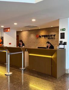 two people sitting at a counter in an airport at Flat Innerbloom Manaus in Manaus +38 photos