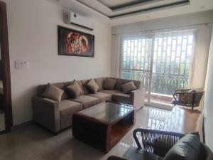 a living room with a couch and a coffee table at Ganga Bliss in Rishīkesh