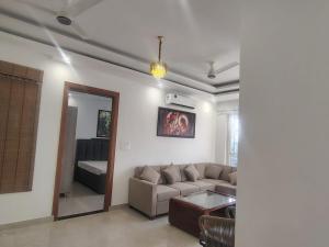 a living room with a couch and a table at Ganga Bliss in Rishīkesh