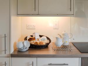 a basket of food on a counter in a kitchen at The Paddock in Saint Hilary