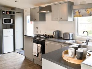 a kitchen with gray cabinets and a counter top at Yolo Retreat in Felton