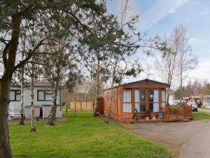 a small cabin in a yard with trees at Yolo Retreat in Felton