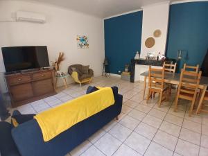 a living room with a couch and a tv at Maison de ville in Pont-Saint-Esprit