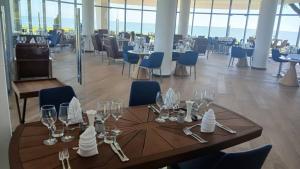 a dining room with a table with wine glasses on it at Gorgora Eco Resort in Gorgora