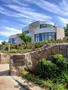a building with a sign in front of a stone wall at Gorgora Eco Resort in Gorgora