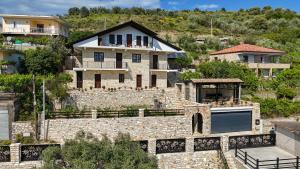 a house on a hill with a garage at Moin Moin Boutique Hotel in Berat