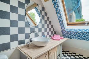 a bathroom with a sink and a mirror at Jūras Vilks in Ventspils