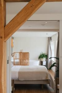 a bedroom with a large bed in a room at Op Oost Boutique hotel & Restaurant het Kook Atelier in Oosterend