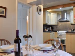 a kitchen with a table with a bottle of wine at Valley View in Burnsall