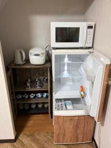 a microwave oven sitting on top of a refrigerator at star in Osaka