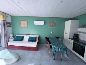 a bedroom with a bed and a table in a room at Maison une chambre avec jardin in Les Sables-d'Olonne