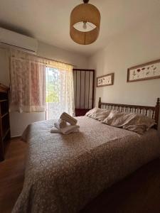 a bedroom with a bed with a stuffed animal on it at Casa rural en La Adrada con jardín in La Adrada