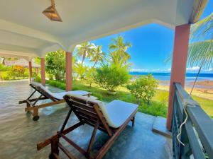 a porch with chairs and a view of the ocean at Ampasoa Beach in Nosy Be