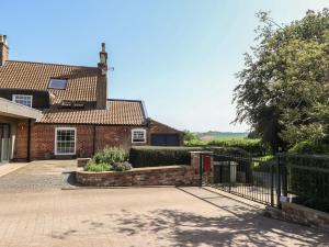 a brick house with a gate in front of it at Ivy House in Louth