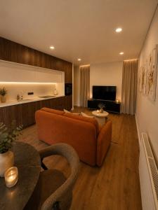 a living room with an orange couch and a table at Luxury apartment in Vilnius