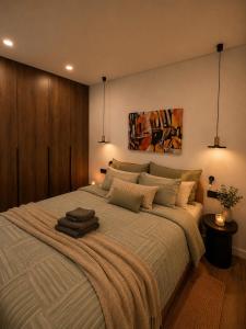 a bedroom with a large bed with pillows on it at Luxury apartment in Vilnius