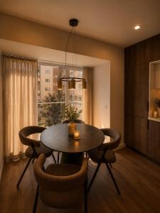 a dining room with a table and chairs and a window at Luxury apartment in Vilnius