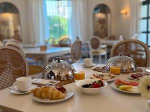 a table with a breakfast of food and orange juice at Villa Jerez in Jerez de la Frontera