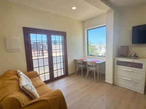 a living room with a couch and a table at Casa Solano in Tías