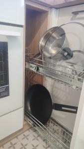 a pans are sitting in an open dishwasher at Viļāni Nākotnes in Viļāni