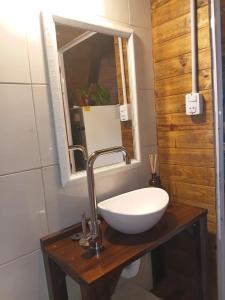 a bathroom with a white sink and a mirror at Cabaña Capitán Viruta in Rosario +12 photos