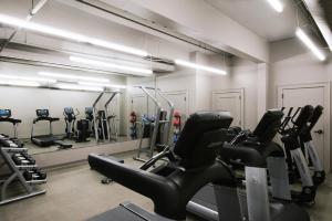 a gym with several treadmills and cardio machines at Hotel Covington Cincinnati Riverfront in Covington
